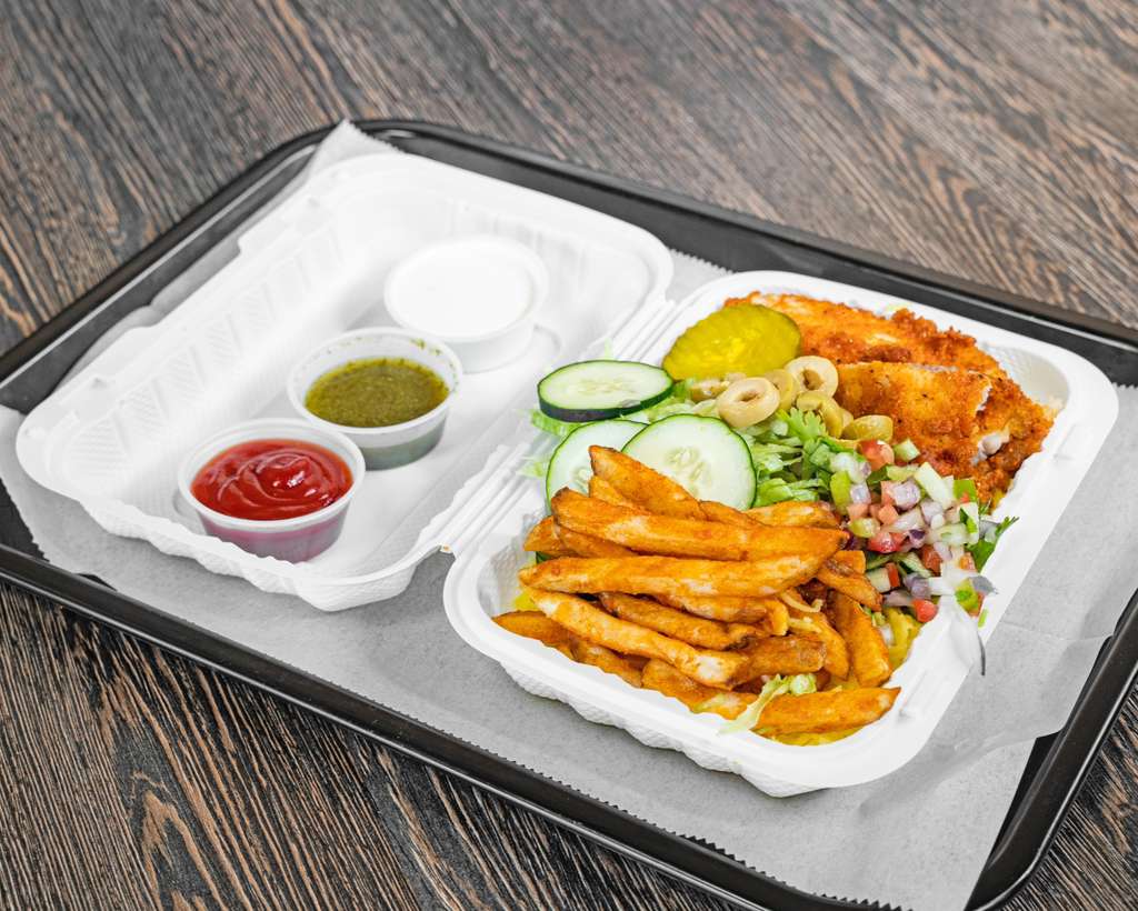 Chicken over rice platter with salad, fries and sauces